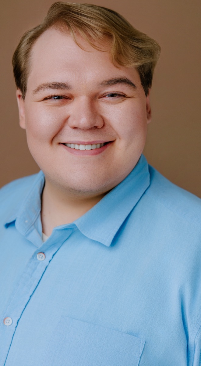 Ethan smiling in a light-blue shirt