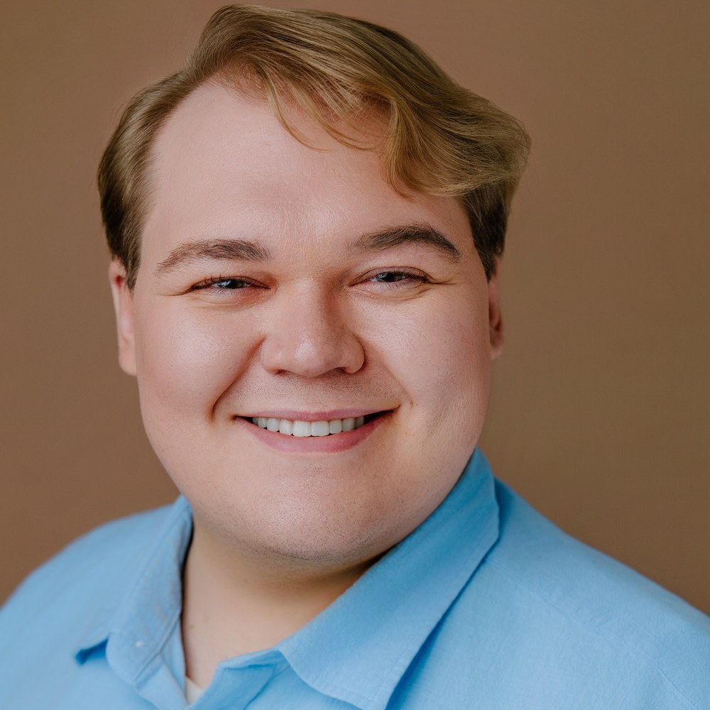 Ethan, smiling in a light-blue shirt